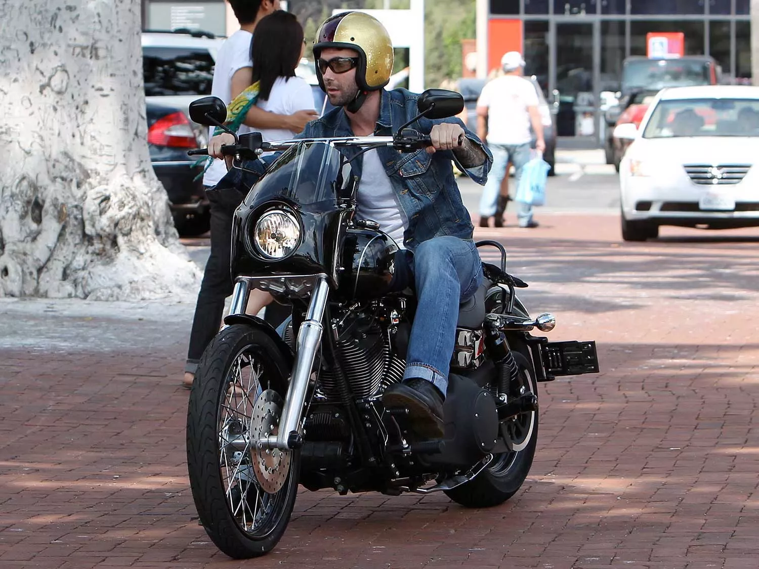 Maroon 5 singer Adam Levine is shown riding through a parking lot in Malibu on his H-D