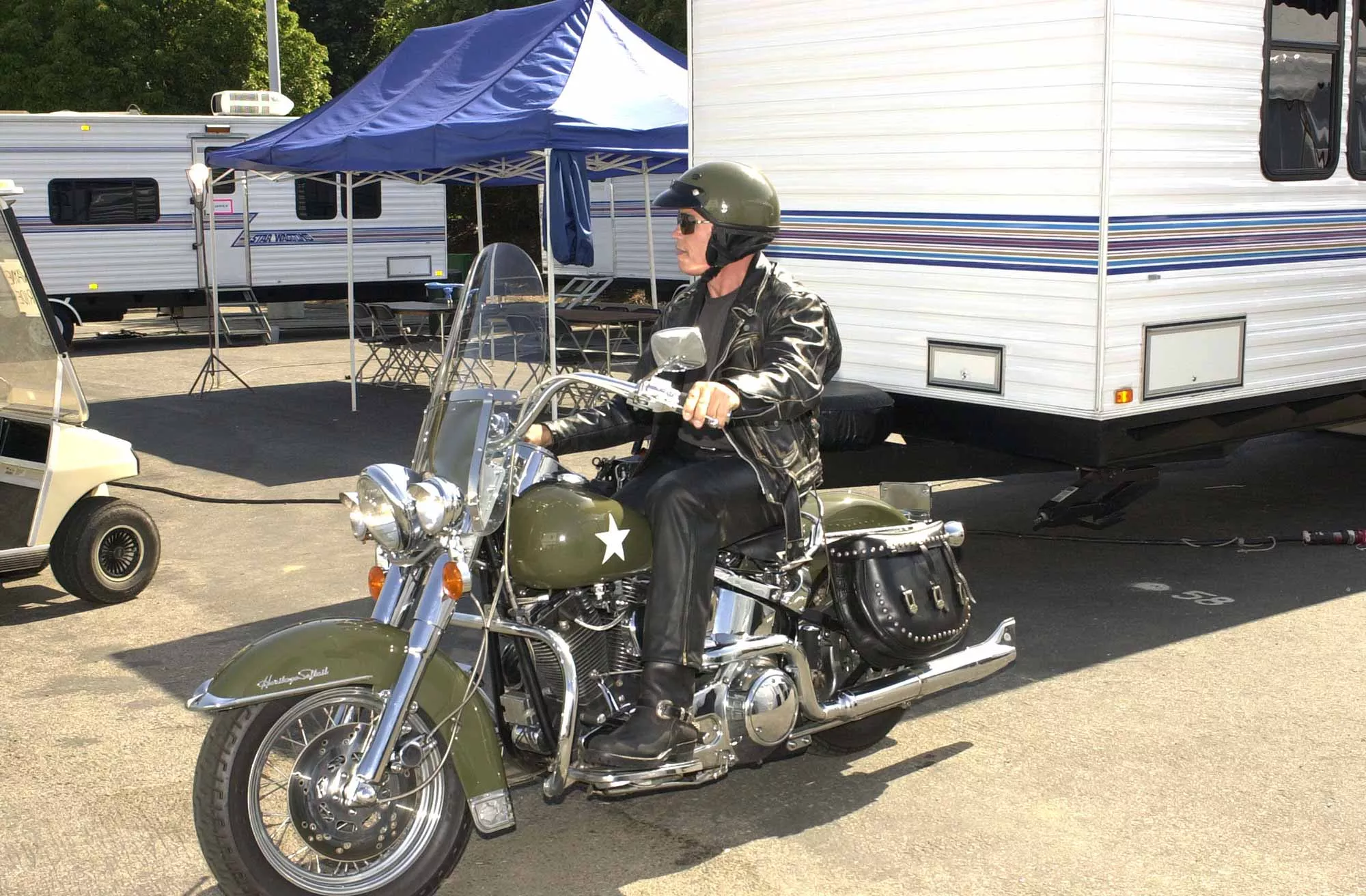 Schwarzenegger is shown here cruising the back lot of Universal Studios in LA on a Heritage Softail.