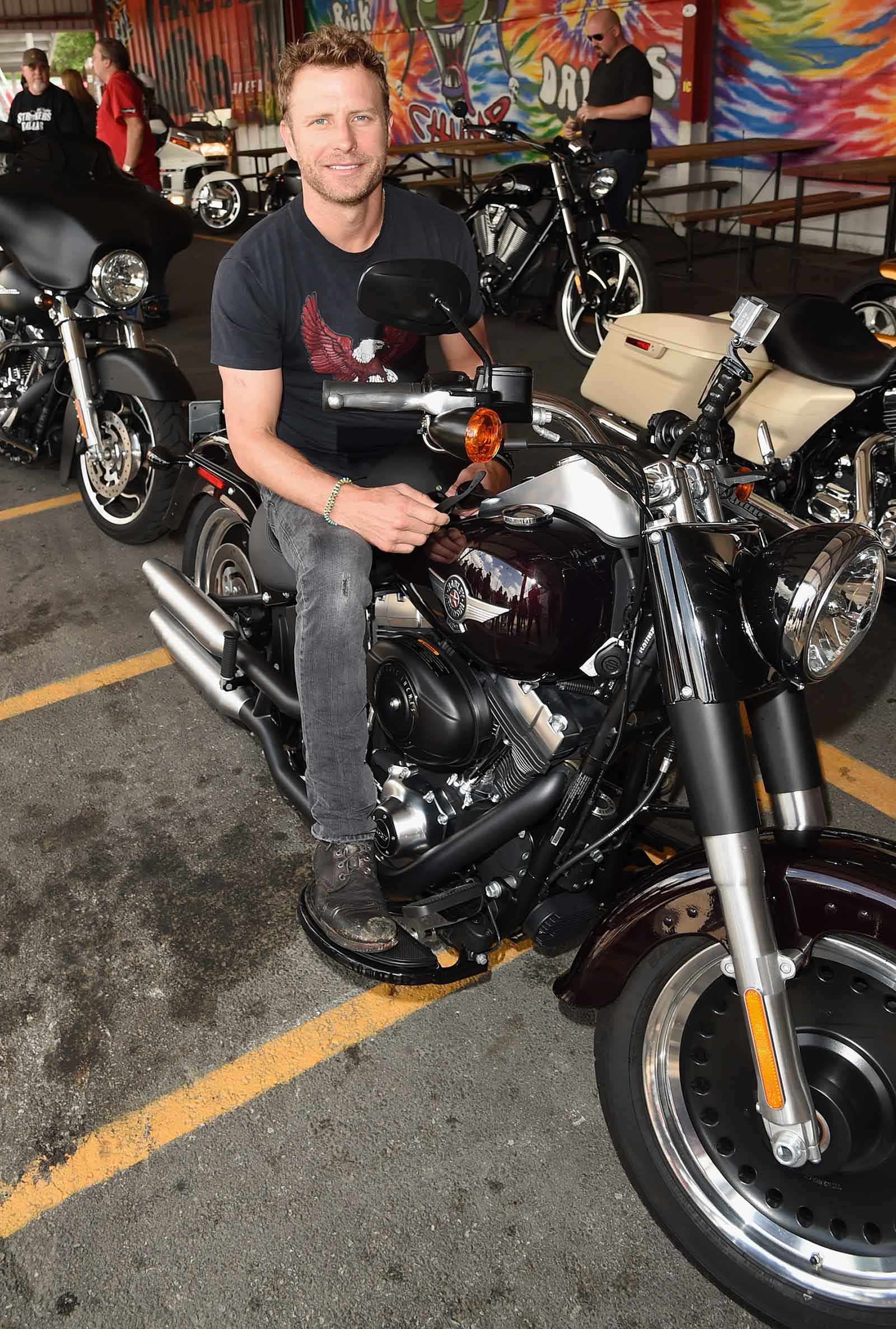 Country star Dierks Bentley poses on a Harley during the ACM Charity Motorcycle Ride & Concert.